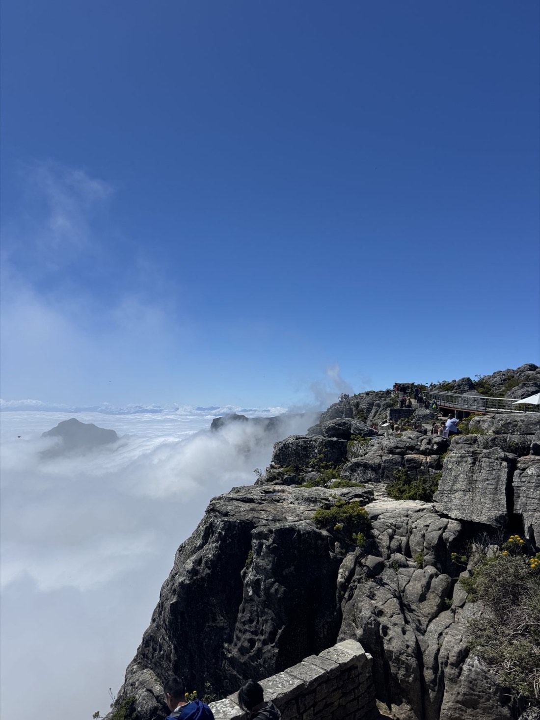 Cloud rolling over the cliff edge at the top of Table Mountain